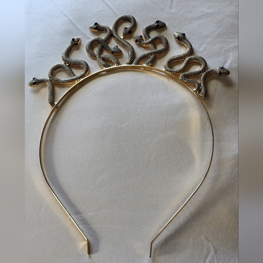 Gold tone snake headband with jewelled eyes